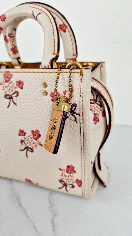 Coach Rogue bags featuring the signature C - hardware for a branded lookCoach 1941 Rogue 17 Floral Bow Chalk White Crossbody Bag Mini Bag in Pebbled Leather - Coach 26835