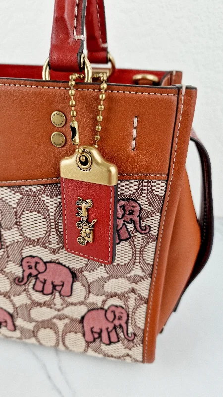 Coach bags with a chain - link trim and a leather body for a modern edgeCoach Rogue 25 Signature Textile Jacquard with Embroidered Pink Elephants Handbag Coach C6165