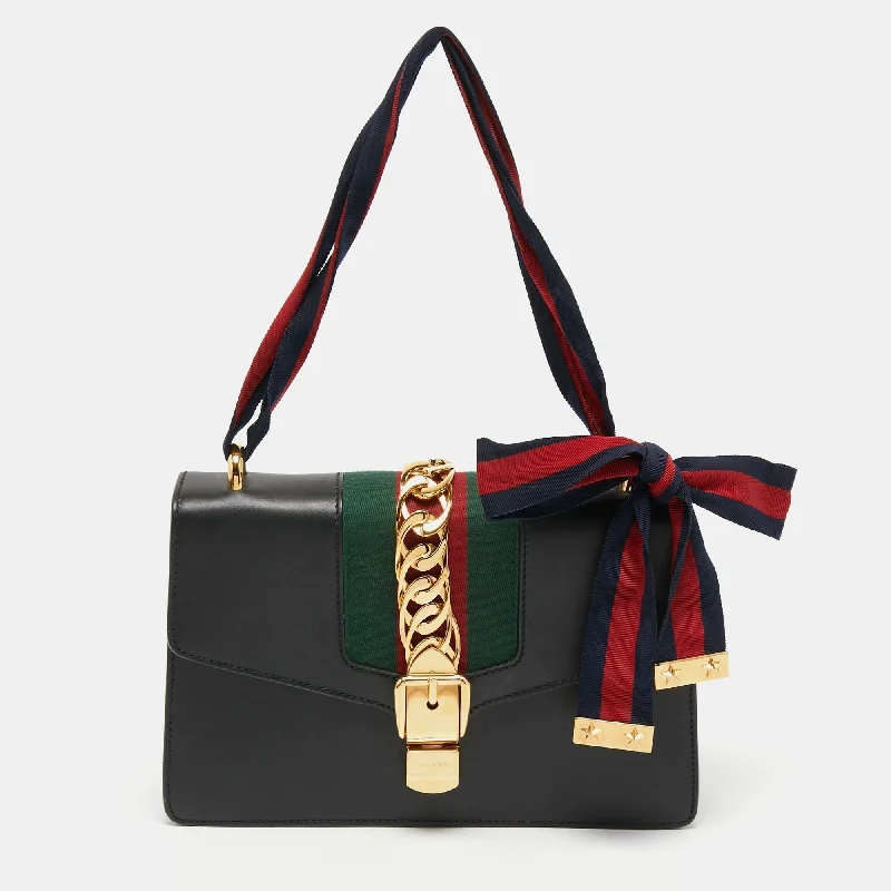 Women Gucci crossbody bags with a printed floral patternGucci Black Leather Small Web Sylvie Shoulder Bag